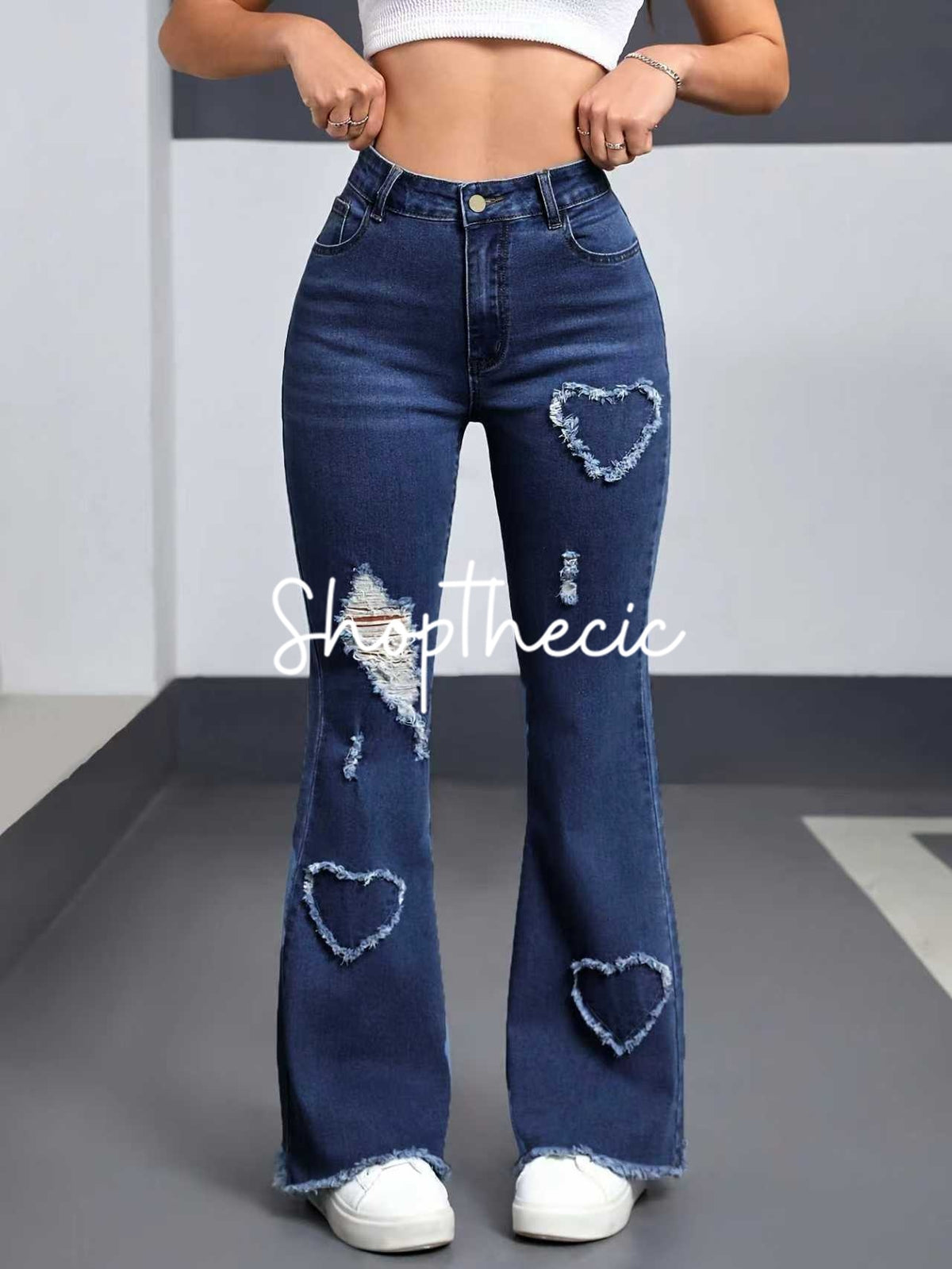 Heart-patterned ripped stretch flared jeans