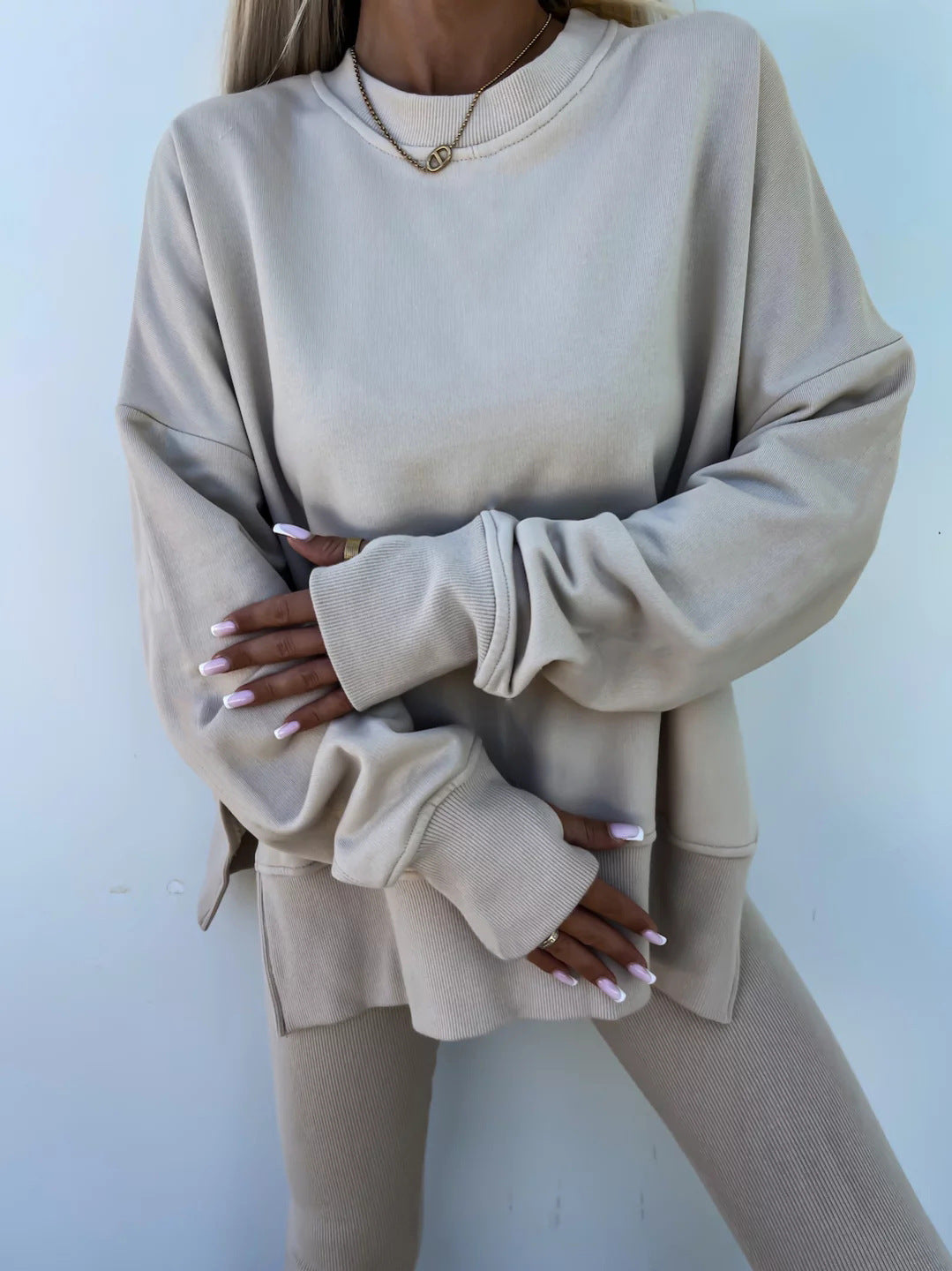 Loose long-sleeved round neck slit top and tight pants two-piece set