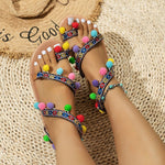 Sandales plates bohème à pompons et brides croisées