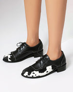 Round toe low-cut suede-trimmed cow-print loafers