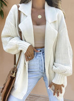 Cardigan long à double poche ouvert sur le devant, manches lanternes, épaules tombantes et revers