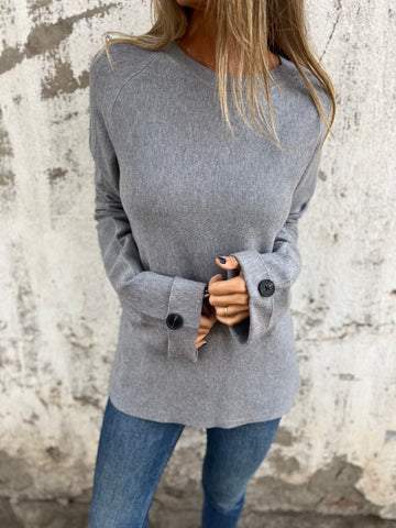 Blusa solta de cor sólida com mangas compridas e punhos abotoados