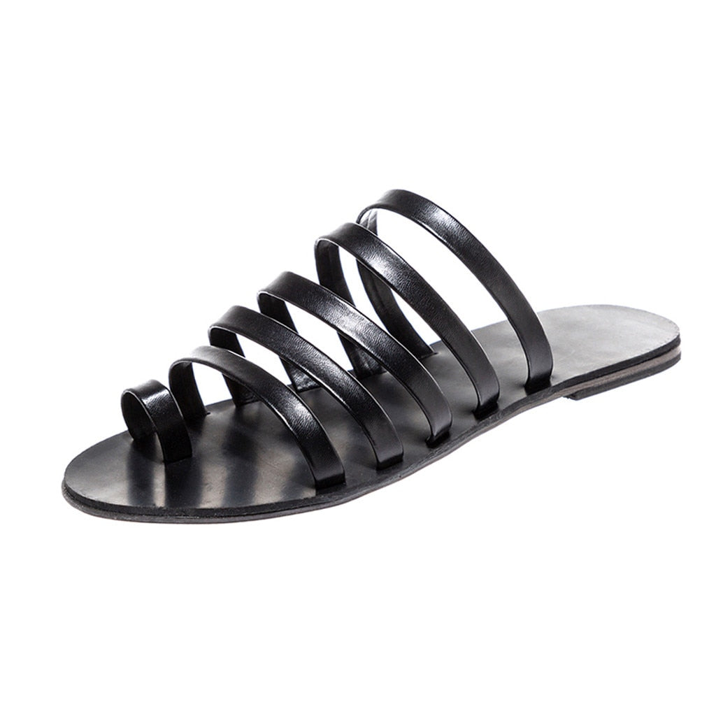 Flache Hausschuhe mit Gladiator-Riemen